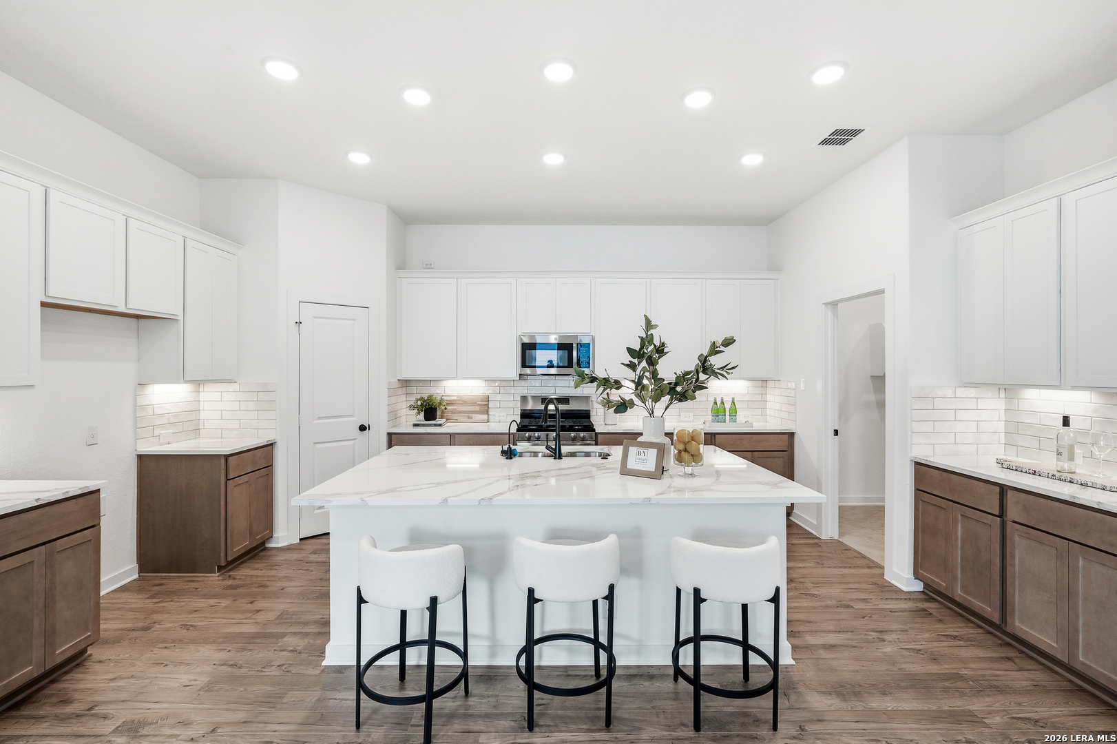 9421 Chatside Schertz, TX 78154 - Photo 22 of 48 a kitchen with stainless steel appliances kitchen island granite countertop a dining table chairs and white cabinets