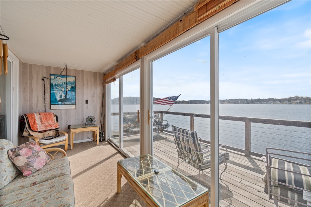 8393 Thrush Road Wolcott, NY 14590 - Photo 19 of 44 Enclosed waterfront porch with a wall of sliding g