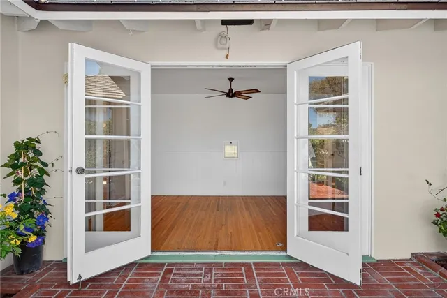 a view of an empty room with a window and potted plant