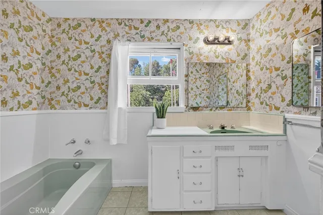 a bathroom with a granite countertop sink a toilet and a bathtub
