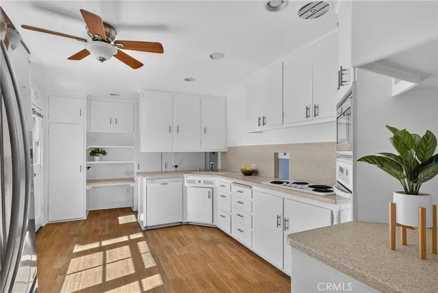 a kitchen with granite countertop cabinets a sink a window and stainless steel appliances