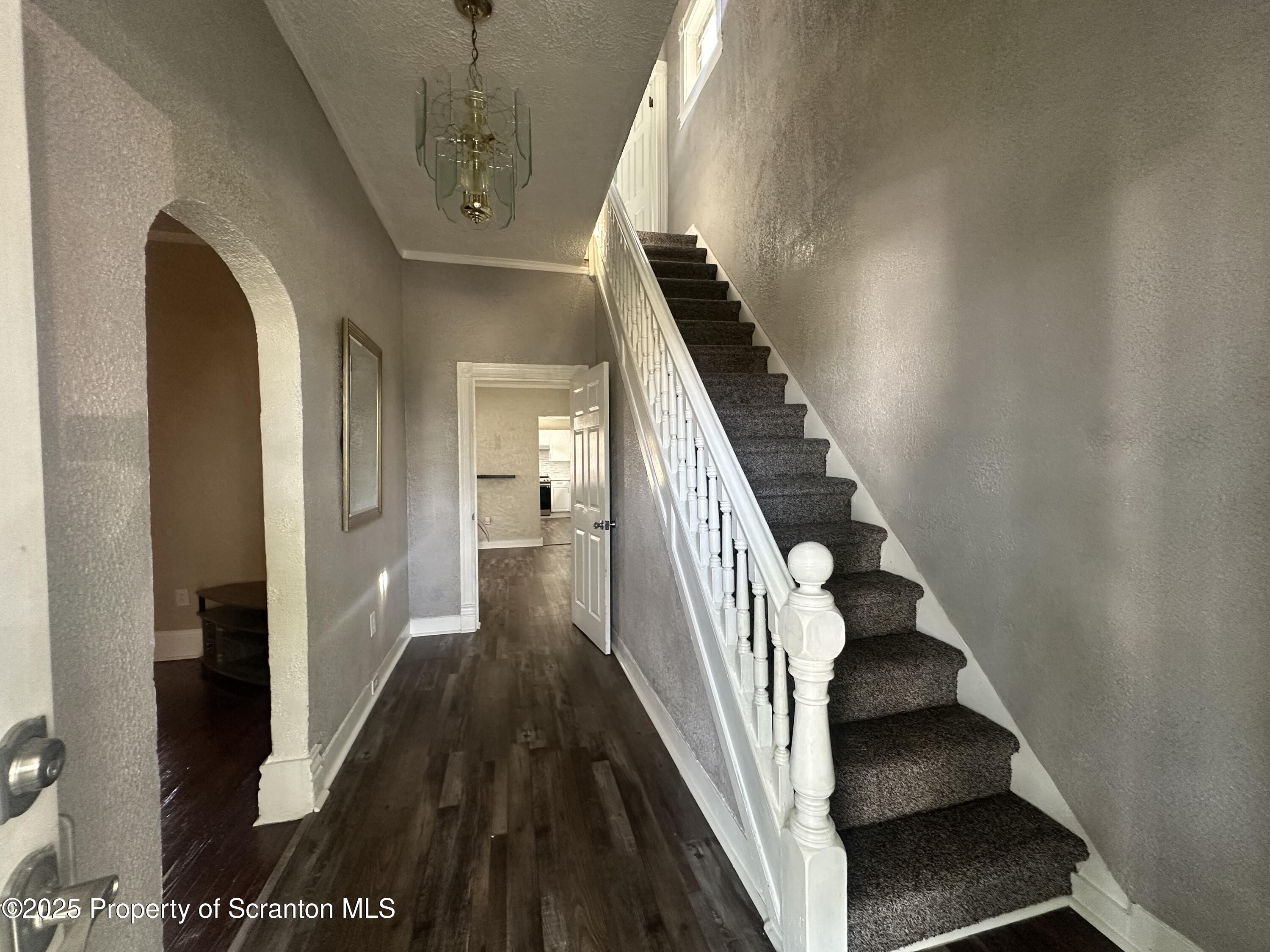 821 Maple Street Scranton, PA 18505 - Photo 8 of 21 a view of a hallway with wooden floor and staircase