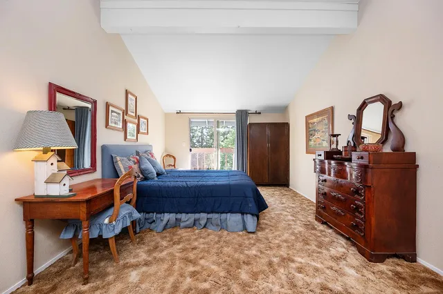 an aerial view of a house with garden space and sitting area