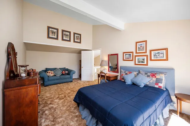an aerial view of a house with a yard and balcony