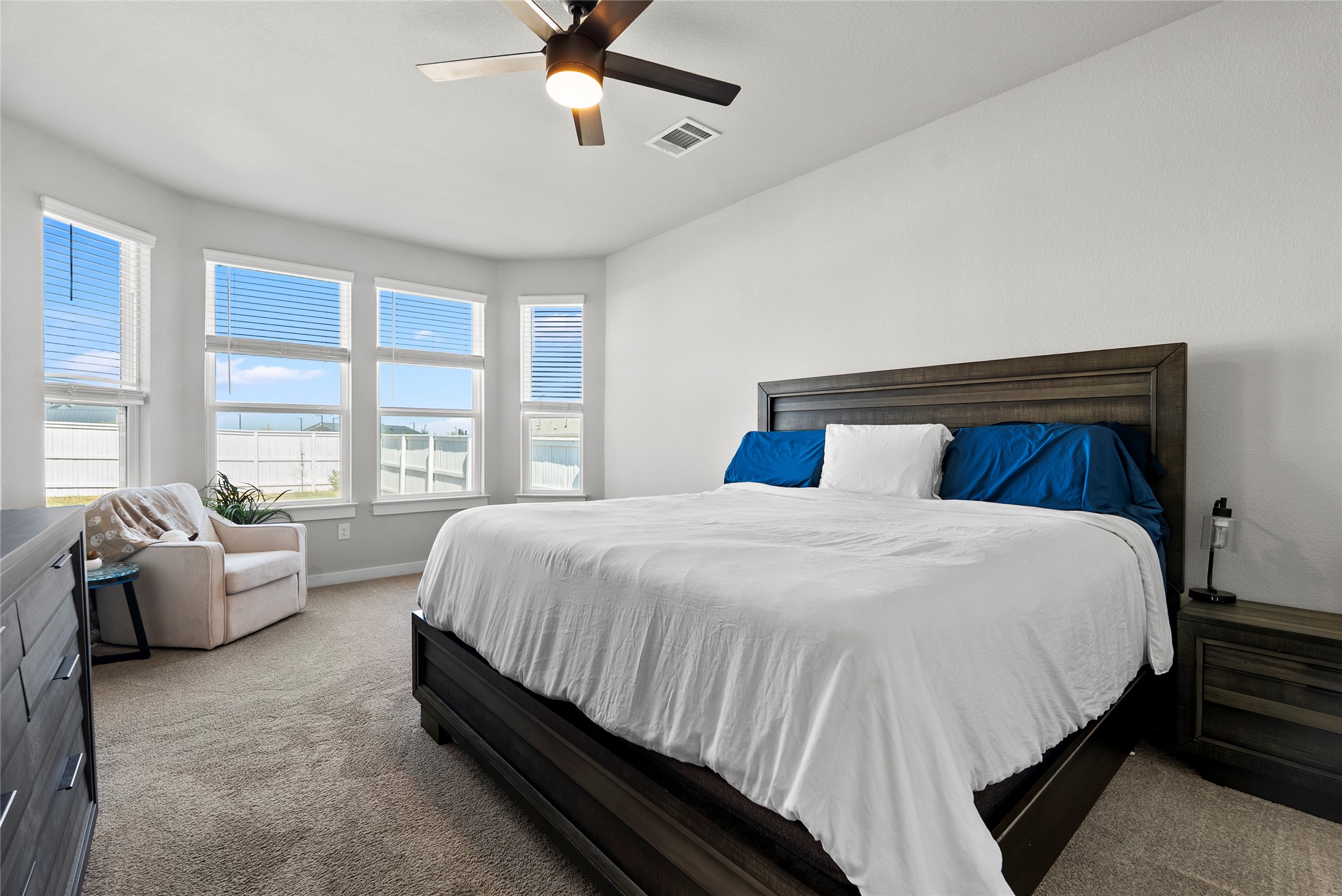 156 Appleberry Lane Elgin, TX 78621 - Photo 12 of 40 Carpeted bedroom with a ceiling fan and large windows