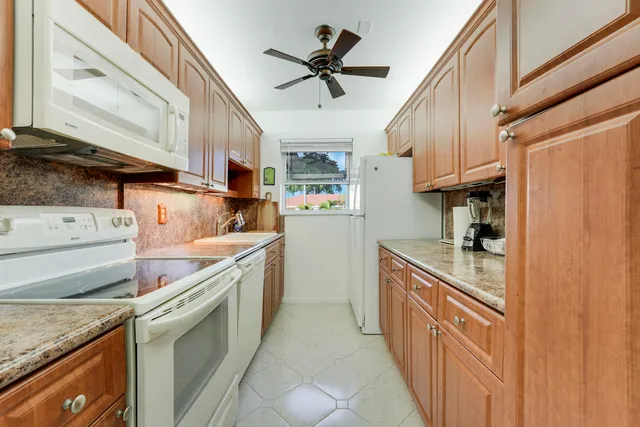 a kitchen with stainless steel appliances granite countertop a sink and cabinets