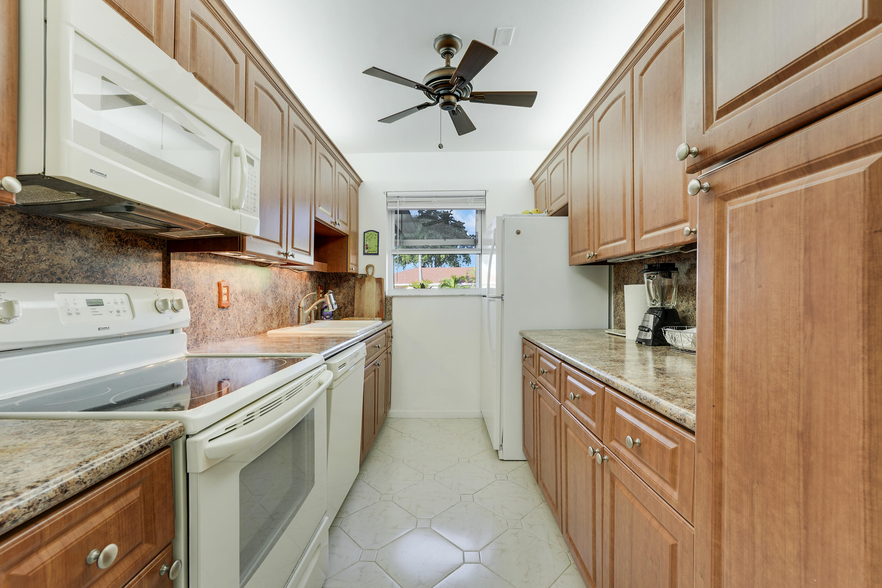 4515 Northwest 3rd Court, Unit C Delray Beach, FL 33445 - Photo 11 of 25 a kitchen with stainless steel appliances granite countertop a sink and cabinets