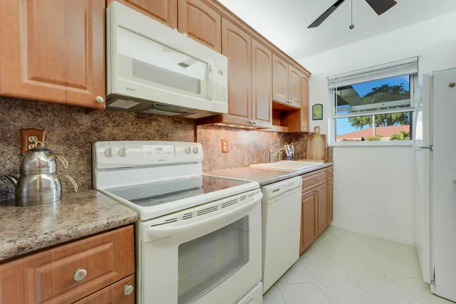 a kitchen with stainless steel appliances granite countertop a sink and a stove