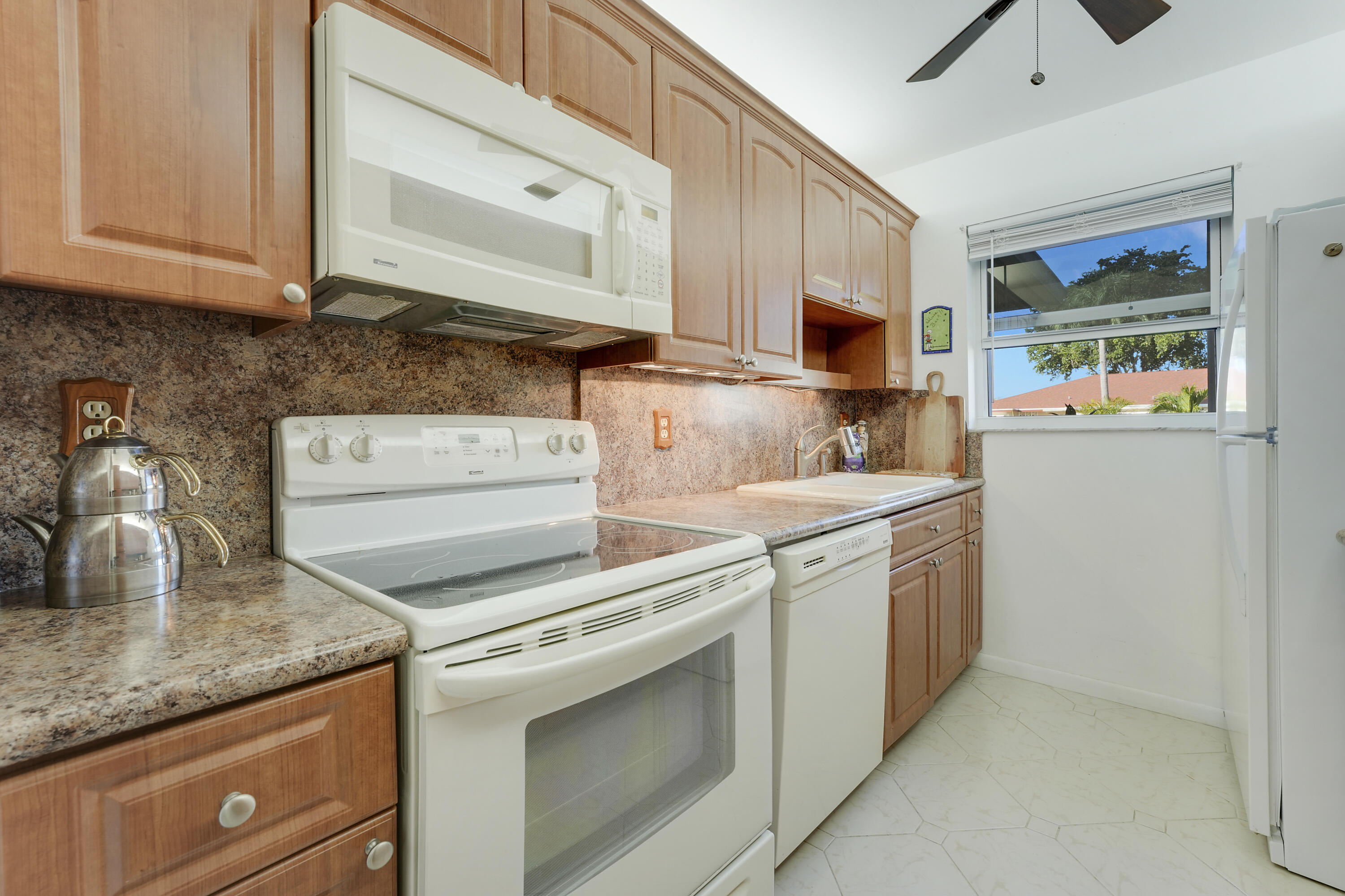 4515 Northwest 3rd Court, Unit C Delray Beach, FL 33445 - Photo 12 of 25 a kitchen with stainless steel appliances granite countertop a sink and a stove