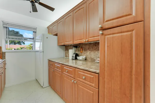 a kitchen with cabinets and window