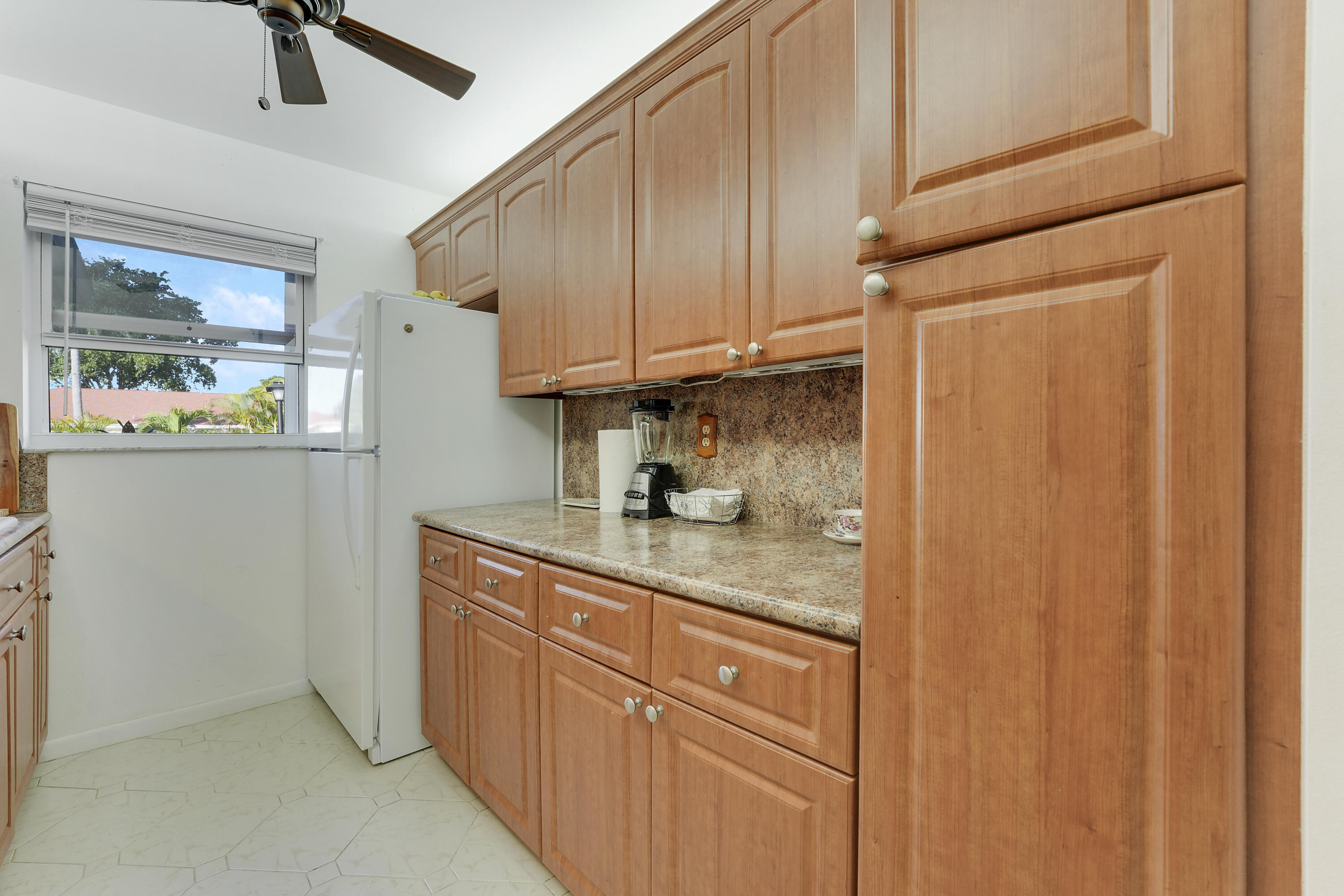4515 Northwest 3rd Court, Unit C Delray Beach, FL 33445 - Photo 13 of 25 a kitchen with cabinets and window