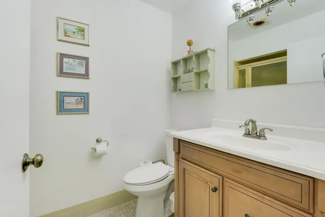 a bathroom with a sink mirror vanity and toilet