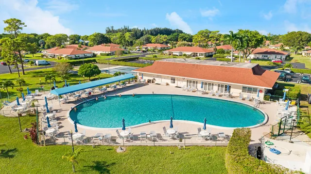 an outdoor space with pool and outdoor seating