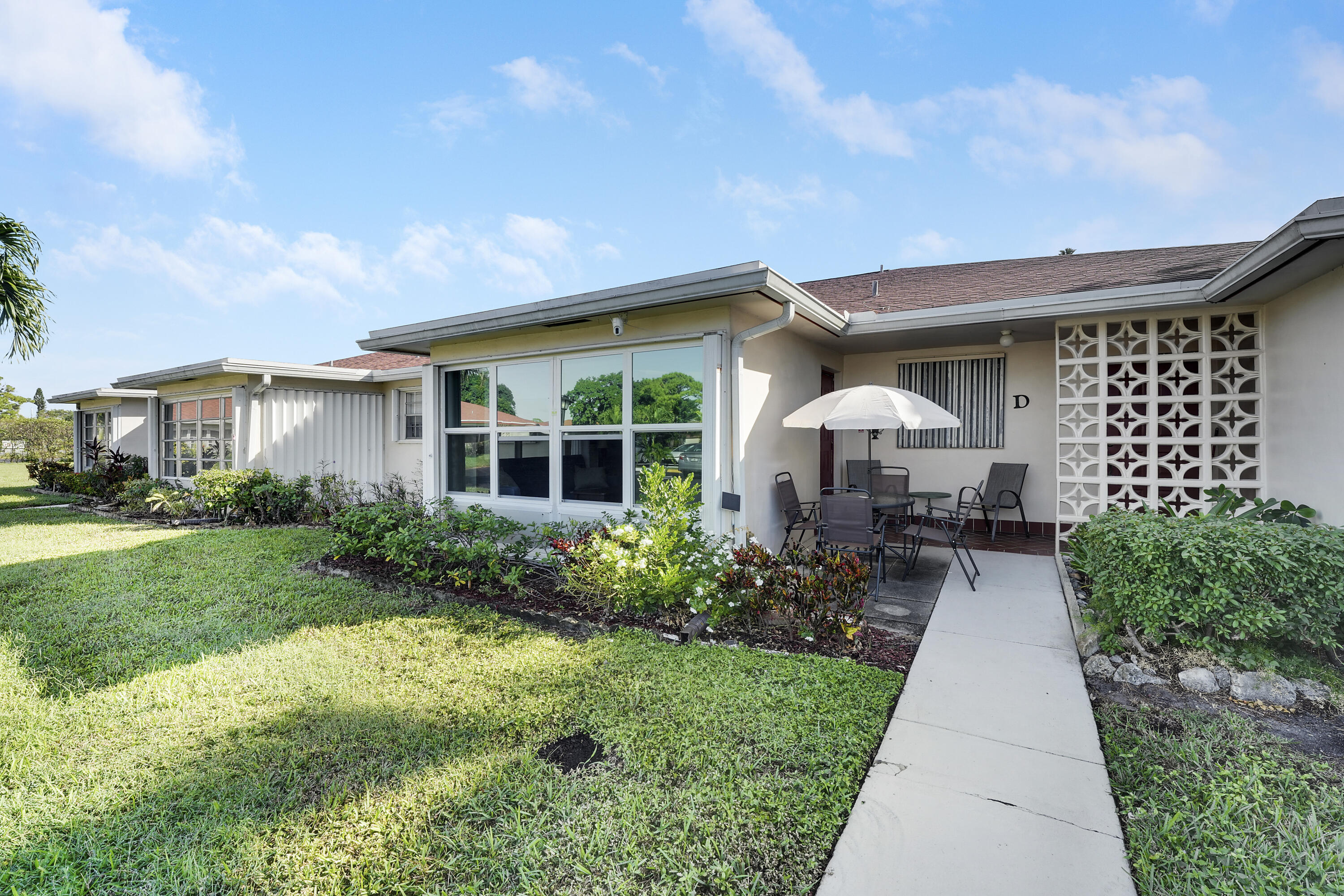 4515 Northwest 3rd Court, Unit C Delray Beach, FL 33445 - Photo 3 of 25 a house view with a garden space