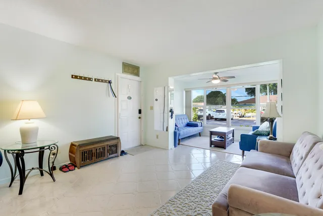 a living room with furniture and a lamp