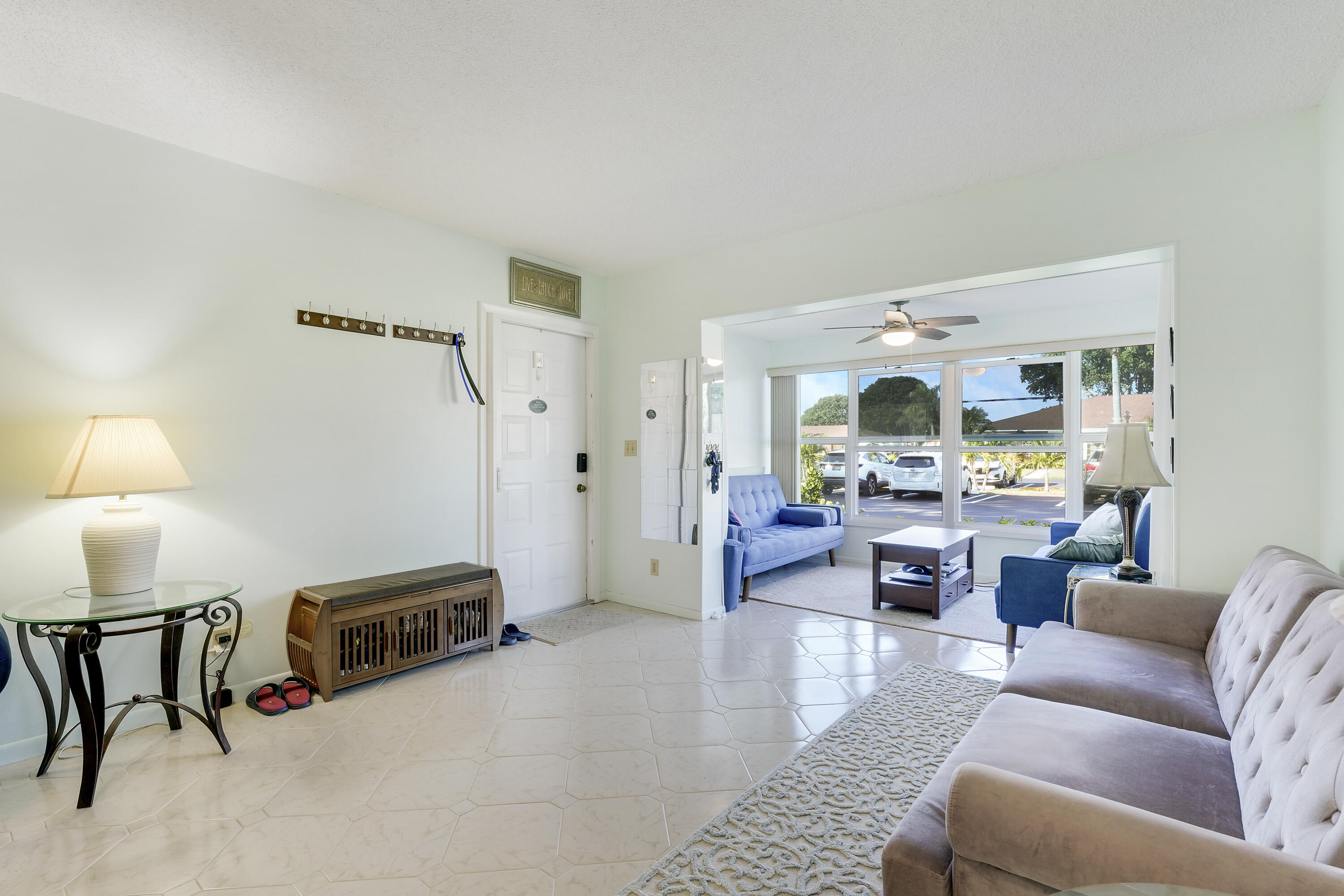 4515 Northwest 3rd Court, Unit C Delray Beach, FL 33445 - Photo 7 of 25 a living room with furniture and a lamp