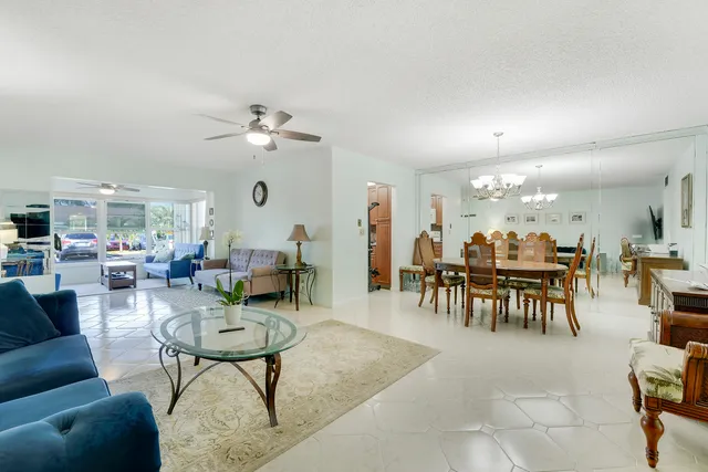 a living room with furniture a table and chairs