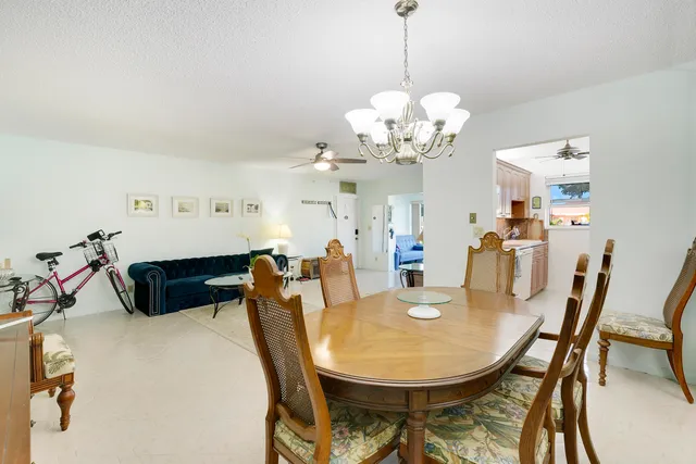 a view of a dining room with furniture and chandelier
