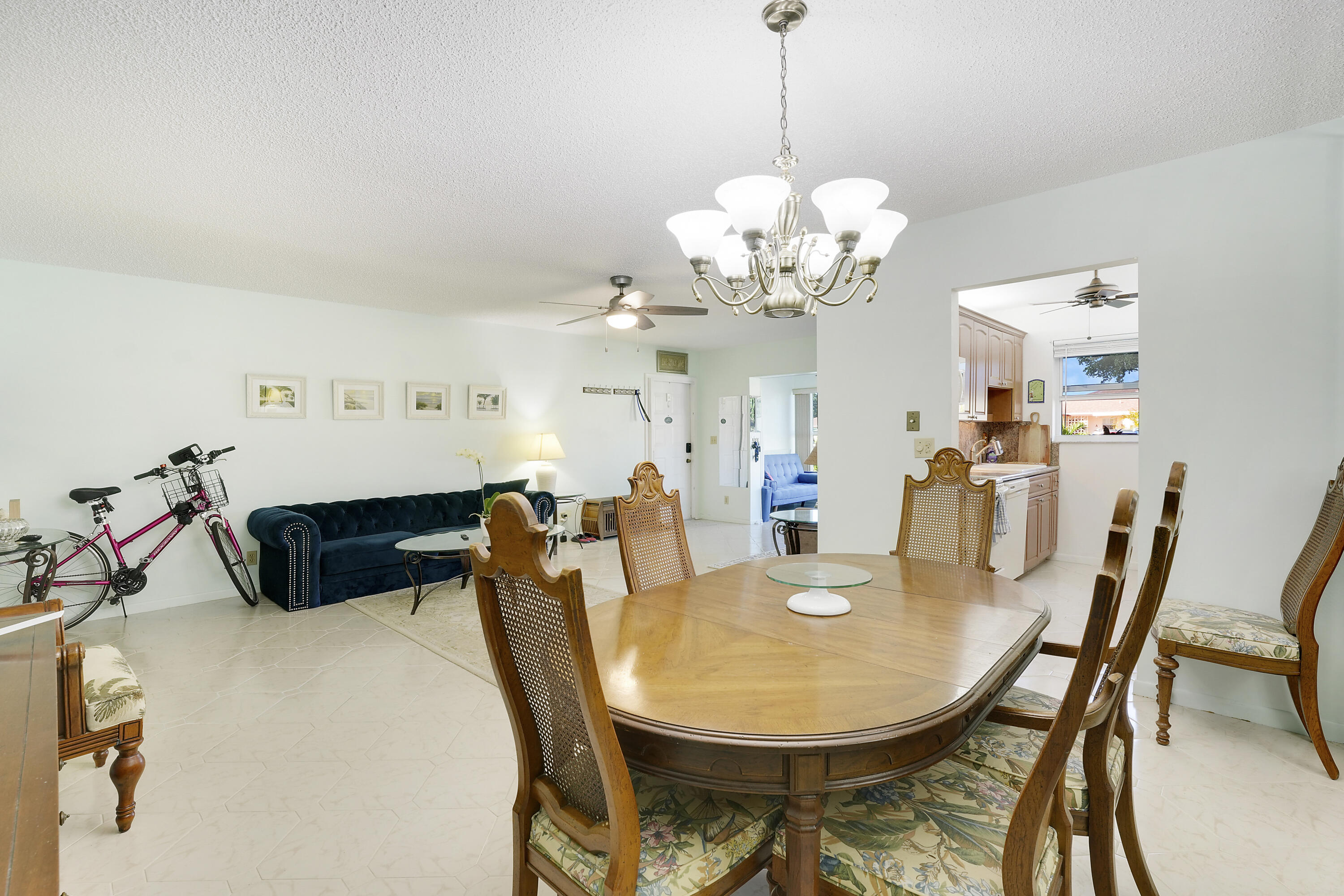 4515 Northwest 3rd Court, Unit C Delray Beach, FL 33445 - Photo 10 of 25 a view of a dining room with furniture and chandelier