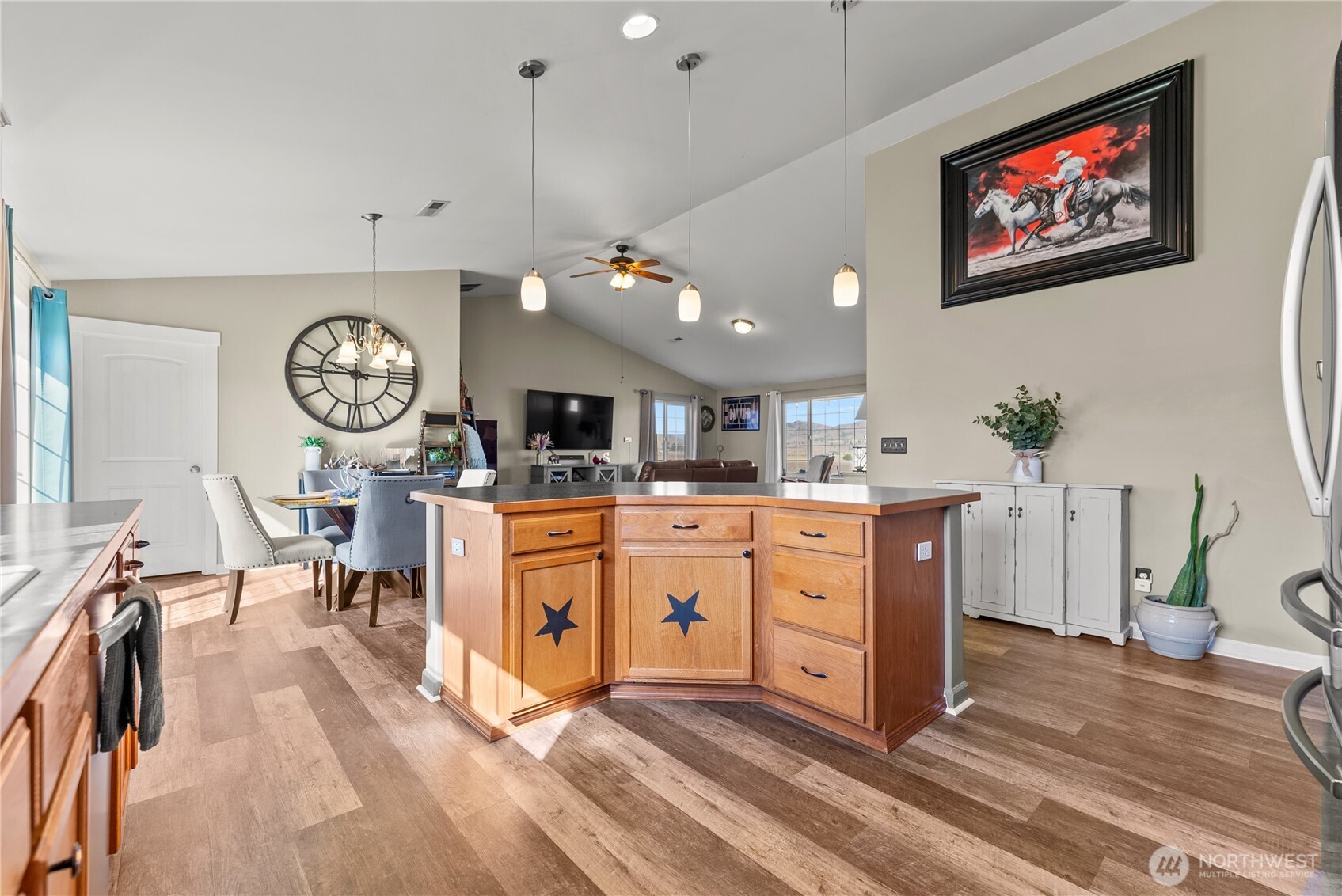 1486 North Star Road Malott, WA 98829 - Photo 11 of 40 a large white kitchen with a large island oven a clock on the wall and a dining table