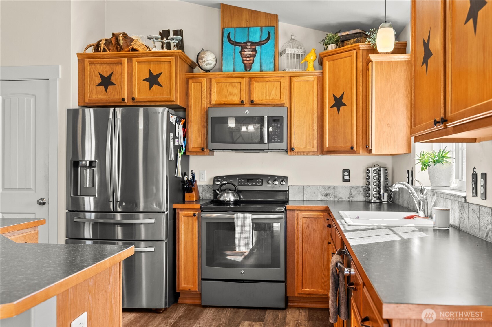 1486 North Star Road Malott, WA 98829 - Photo 13 of 40 a kitchen with stainless steel appliances granite countertop a stove a sink and a microwave