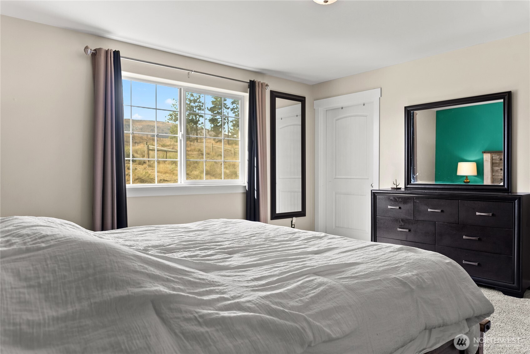 1486 North Star Road Malott, WA 98829 - Photo 24 of 40 a bedroom with a bed and a dresser with mirror