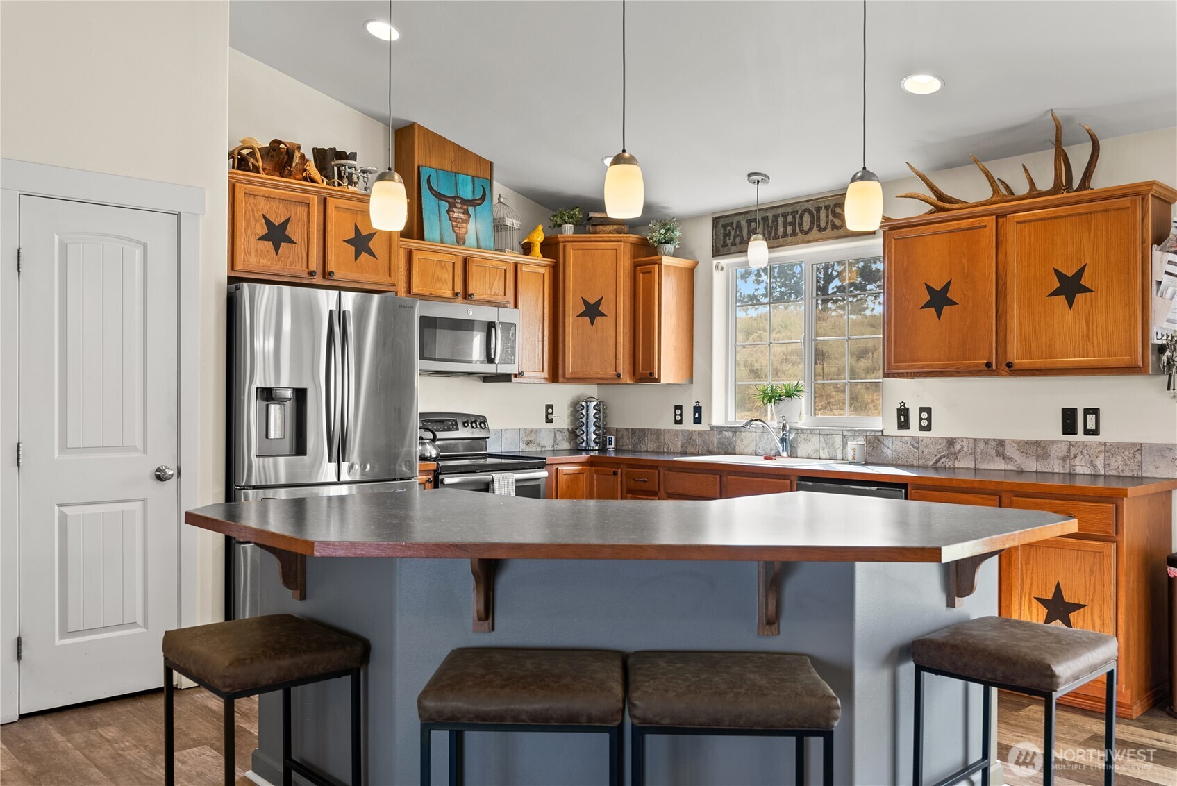 1486 North Star Road Malott, WA 98829 - Photo 9 of 40 a kitchen with stainless steel appliances granite countertop a sink and a refrigerator