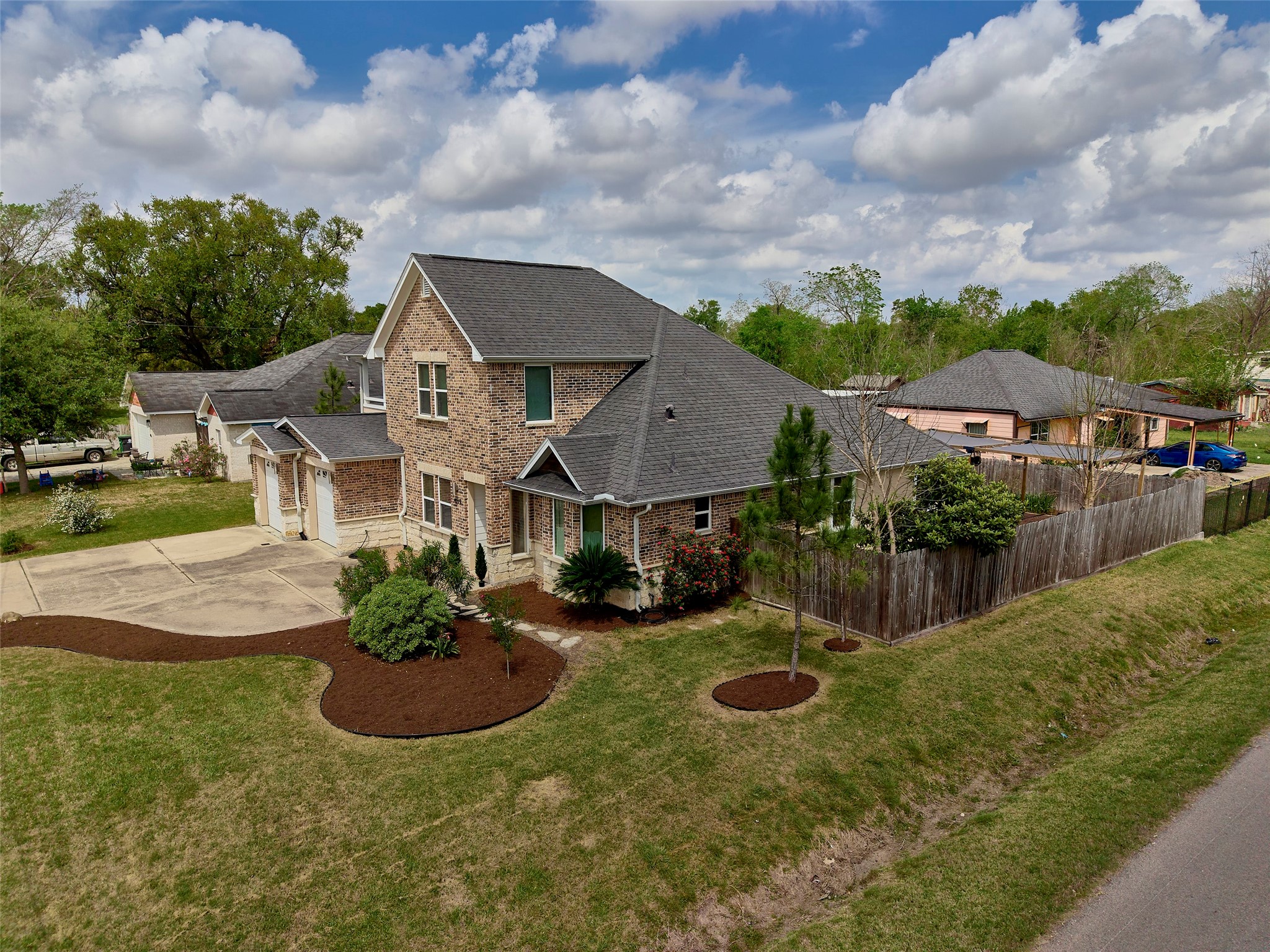 4219 Redbud Street Houston, TX 77051 - Photo 2 of 25 Discover your dream home on a spacious corner lot, featuring a charming brick facade, lush landscaping, and ample driveway space for easy living and entertaining.