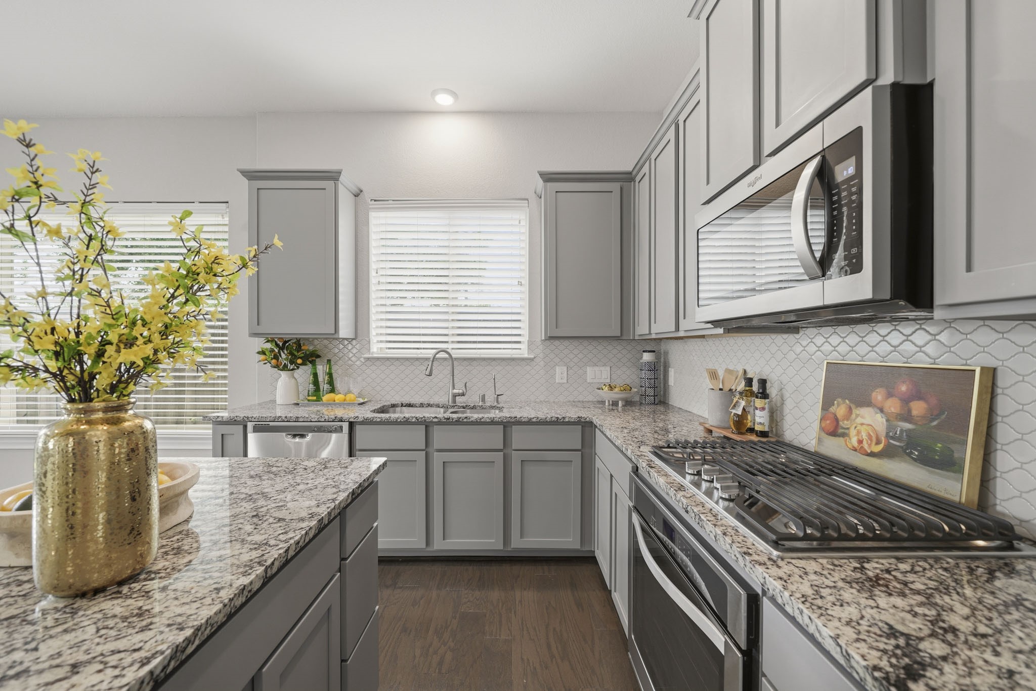 4103 Tranquil Square Road Houston, TX 77043 - Photo 13 of 39 The kitchen is outfitted with a Whirlpool oven, four-burner gas cooktop, microwave and a dual basin stainless steel sink with recessed lighting. Their is also a filtered water dispenser on the sink.
