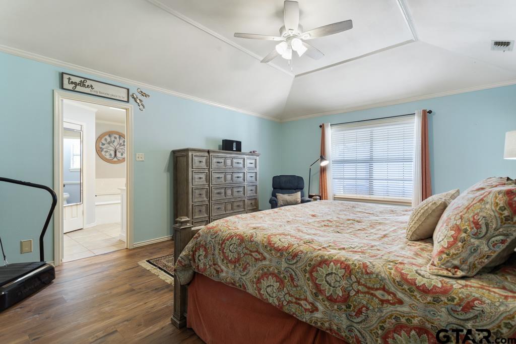 6005 Raleigh Drive Tyler, TX 75703 - Photo 16 of 35 a bedroom with a large bed dresser and a window