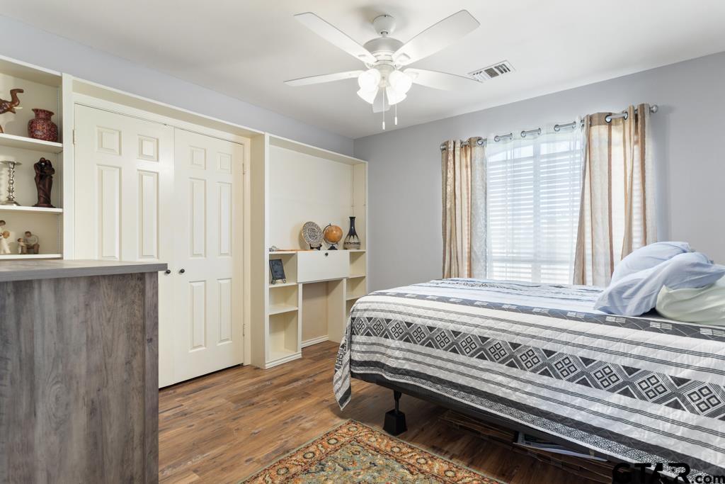 6005 Raleigh Drive Tyler, TX 75703 - Photo 21 of 35 a bedroom with a bed and a window