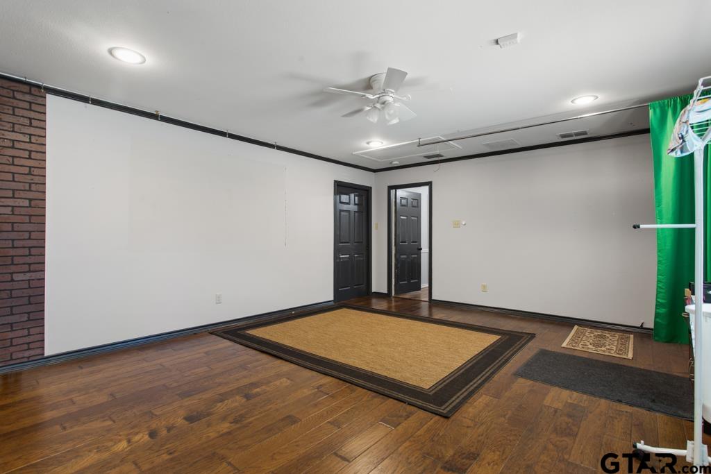 6005 Raleigh Drive Tyler, TX 75703 - Photo 27 of 35 an empty room with wooden floor and entryway