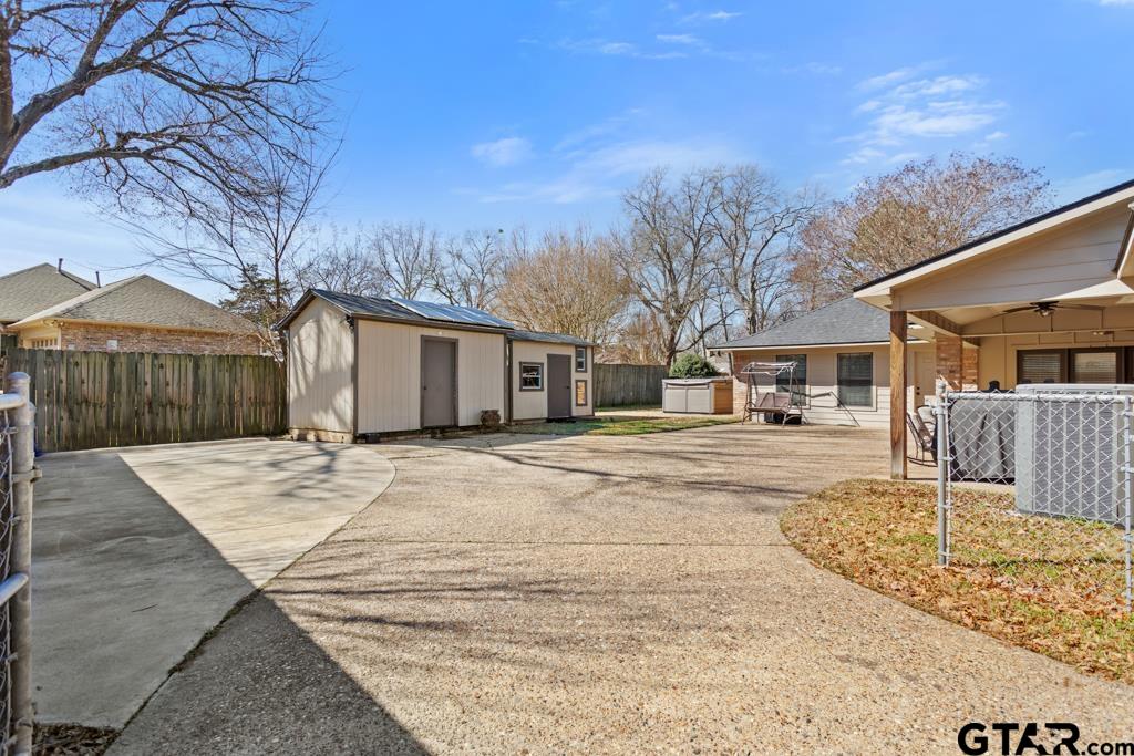 6005 Raleigh Drive Tyler, TX 75703 - Photo 32 of 35 a view of a white house with a large tree in front of it