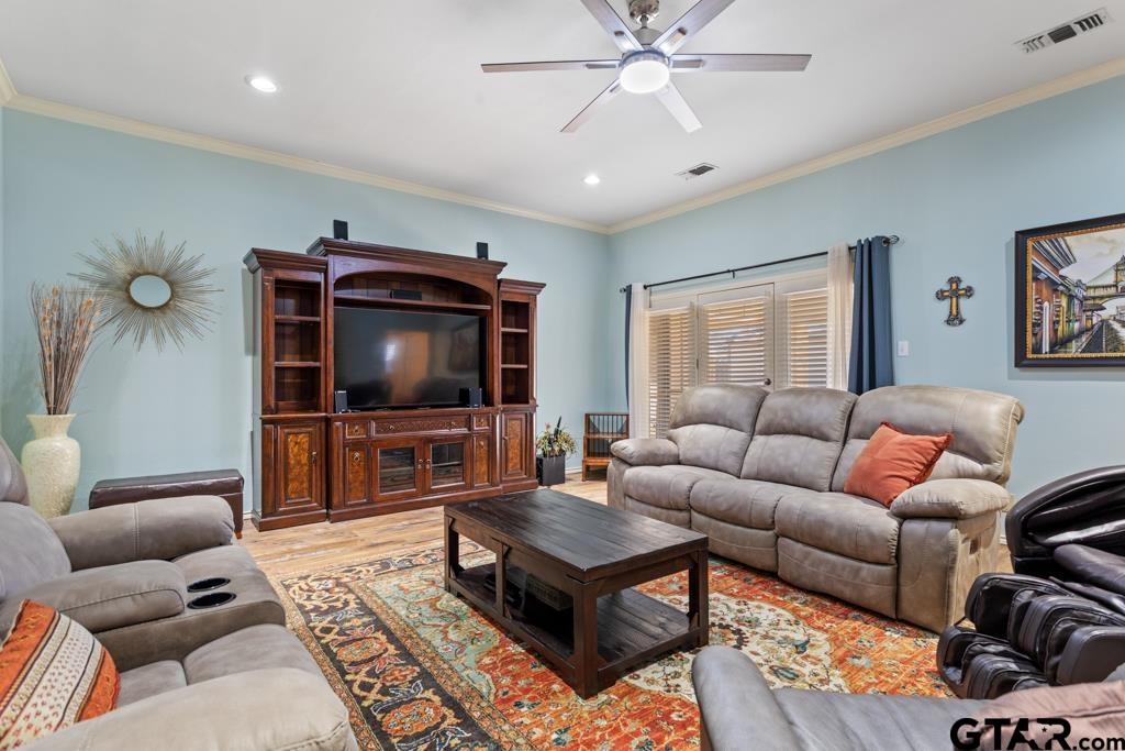 6005 Raleigh Drive Tyler, TX 75703 - Photo 4 of 35 a living room with furniture and a flat screen tv