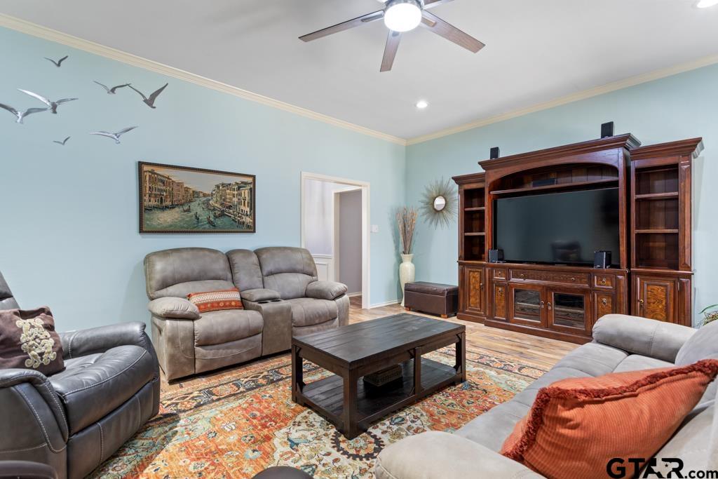 6005 Raleigh Drive Tyler, TX 75703 - Photo 6 of 35 a living room with furniture and a flat screen tv