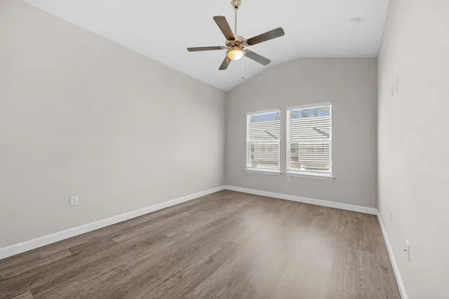 a view of a room with wooden floor