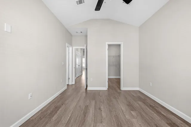 a view of a room with wooden floor