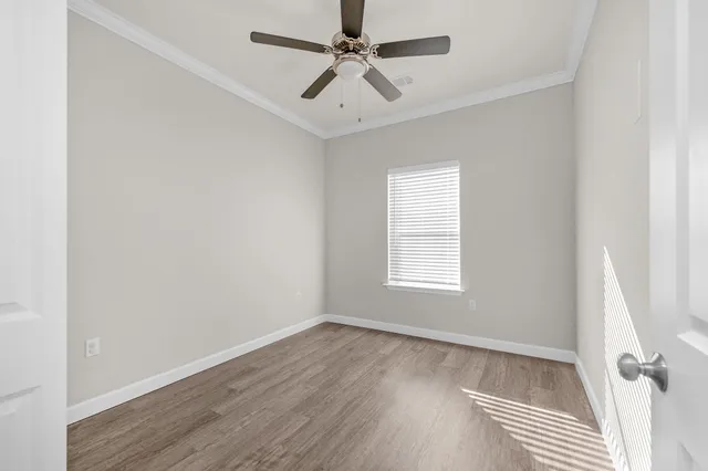 wooden floor in an empty room with a window