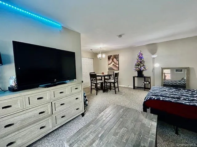 a bedroom with furniture and a flat screen tv