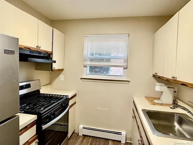 a kitchen that has a sink and a stove