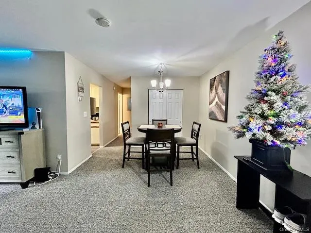 a view of a dining room with furniture and a potted plant