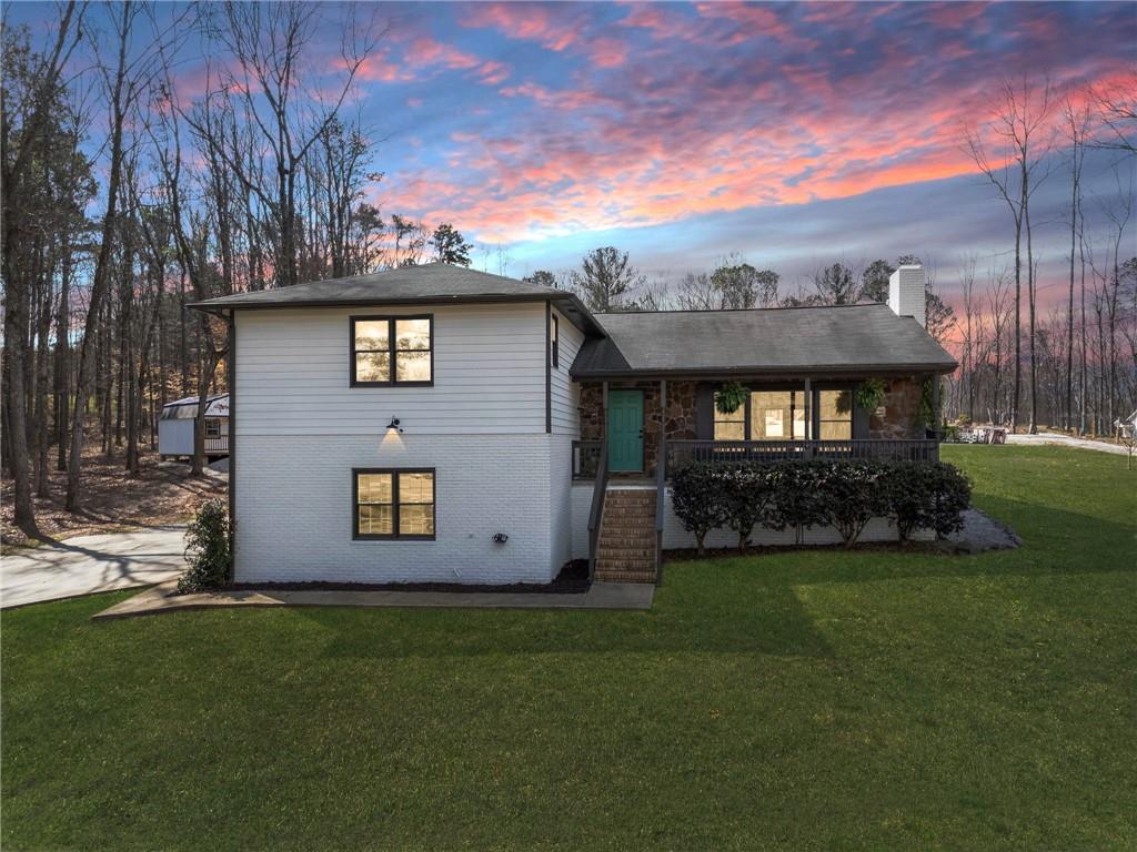 a front view of a house with a garden