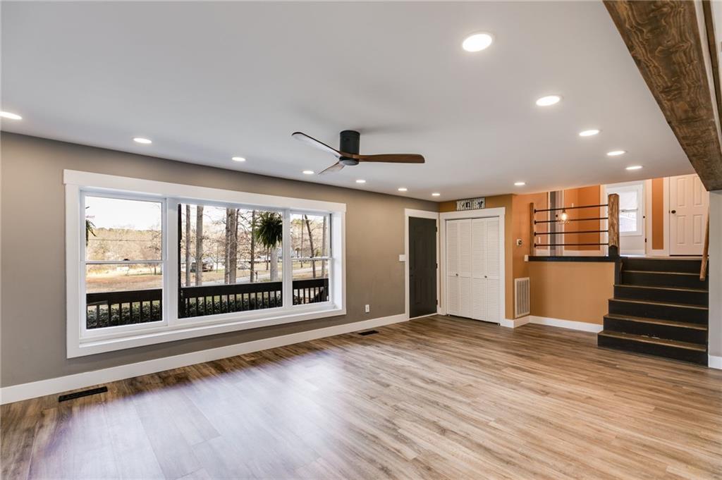 118 Raven Road Villa Rica, GA 30180 - Photo 11 of 59 an empty room with wooden floor and windows