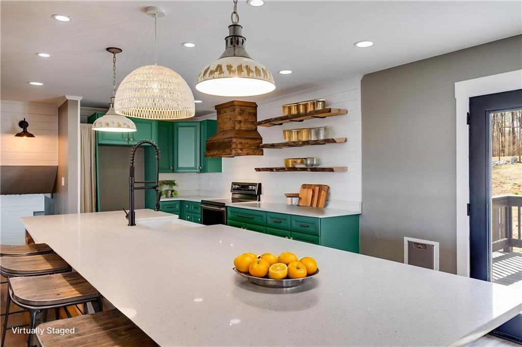 118 Raven Road Villa Rica, GA 30180 - Photo 17 of 59 a kitchen with stainless steel appliances granite countertop a sink a stove and a wooden floors