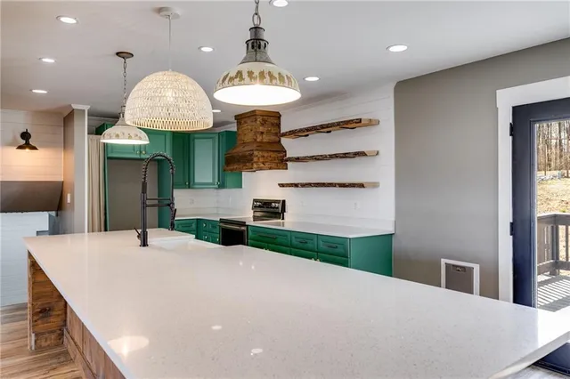 a kitchen with a sink and wooden floor