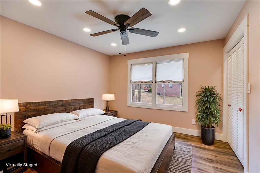 118 Raven Road Villa Rica, GA 30180 - Photo 30 of 59 a bedroom with a large bed and a chandelier