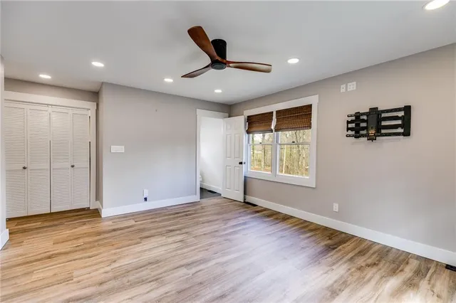 a view of an empty room with wooden floor