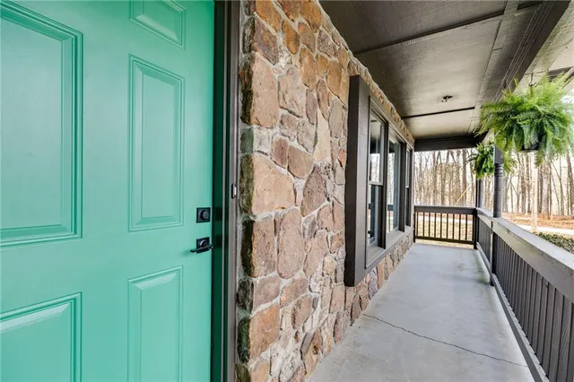 a living room with furniture a fireplace and a large window