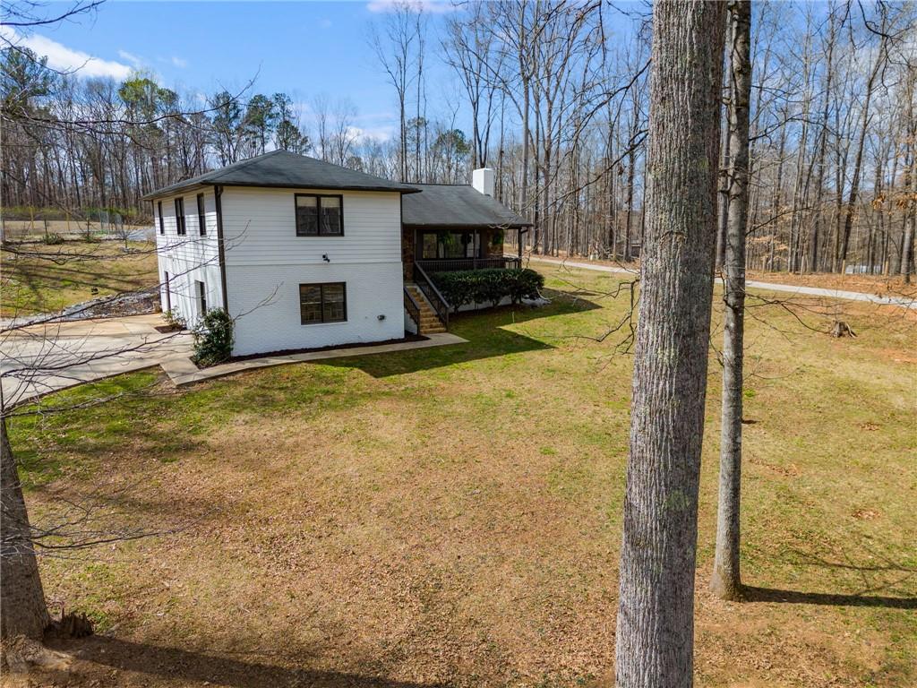 118 Raven Road Villa Rica, GA 30180 - Photo 59 of 59 a view of a house with backyard and trees in the background