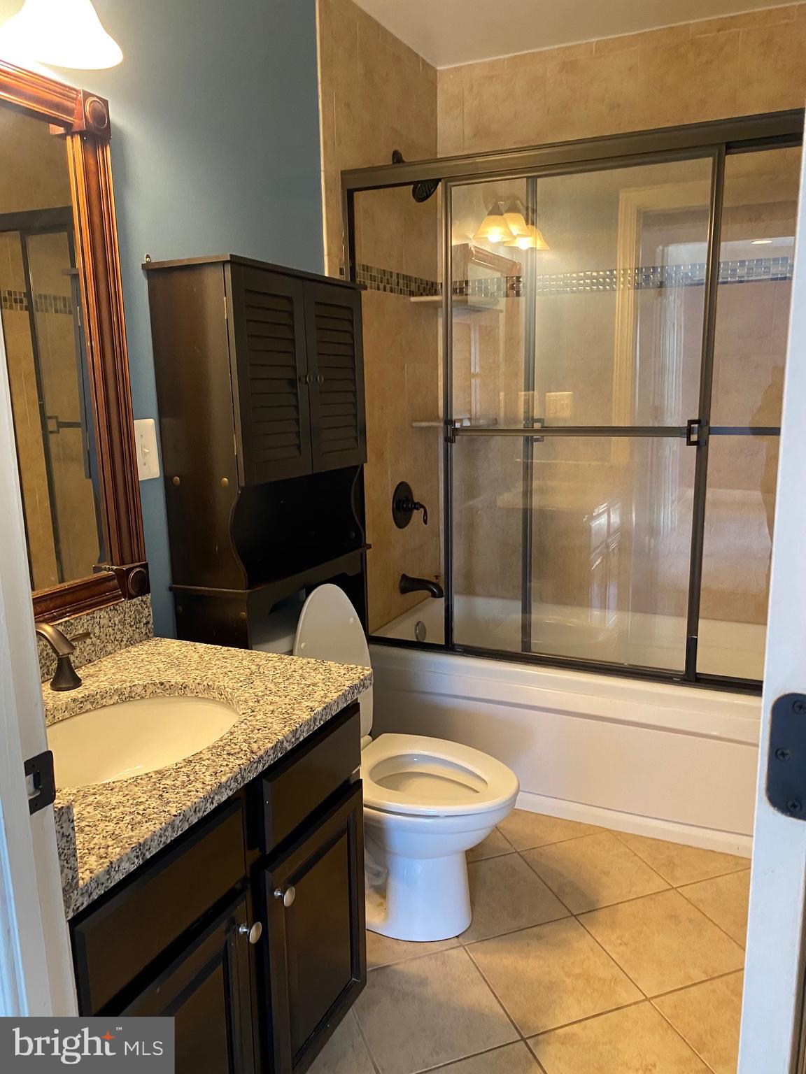 1403 Gleason Street Silver Spring, MD 20902 - Photo 14 of 34 a bathroom with a granite countertop sink toilet and shower